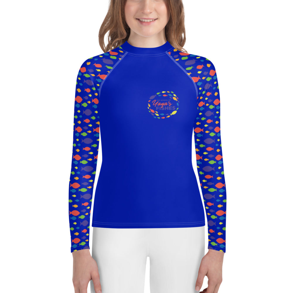 Description: Raglan rashguard in blue with The School of Yaya’s Fishes logos on front and back and Fish Print on sleeves.