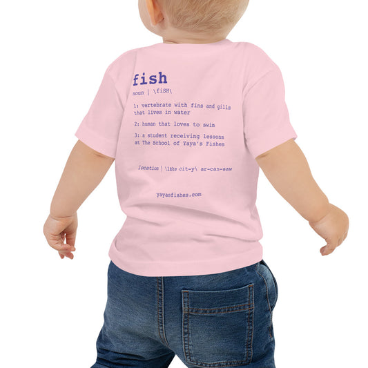 Description: Light Pink Tee shirt with definition on the back in purple font. Fish. Noun. 1: Vertebrate with fins and gills that lives in the water. 2: human that loves to swim. 3: a student receiving lessons at The School of Yaya’s Fishes. Location: Lake City, Arkansas written in phonetics. Yayasfishes.com.