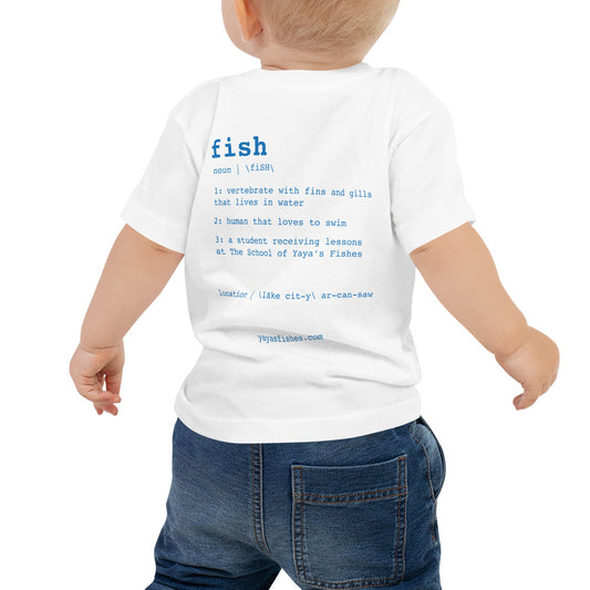 Description: White Tee shirt with definition on the back in blue font. Fish. Noun. 1: Vertebrate with fins and gills that lives in the water. 2: human that loves to swim. 3: a student receiving lessons at The School of Yaya’s Fishes. Location: Lake City, Arkansas written in phonetics. Yayasfishes.com.