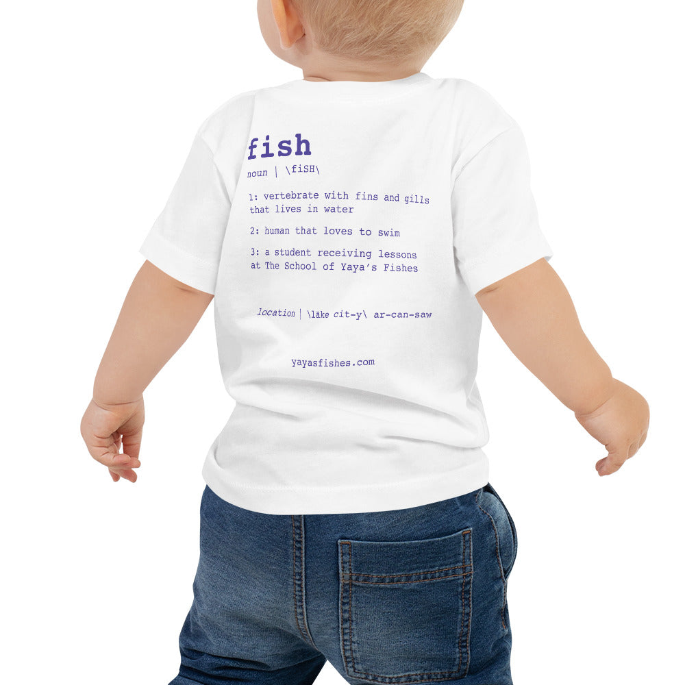 Description: White Tee shirt with definition on the back in purple font. Fish. Noun. 1: Vertebrate with fins and gills that lives in the water. 2: human that loves to swim. 3: a student receiving lessons at The School of Yaya’s Fishes. Location: Lake City, Arkansas written in phonetics. Yayasfishes.com.