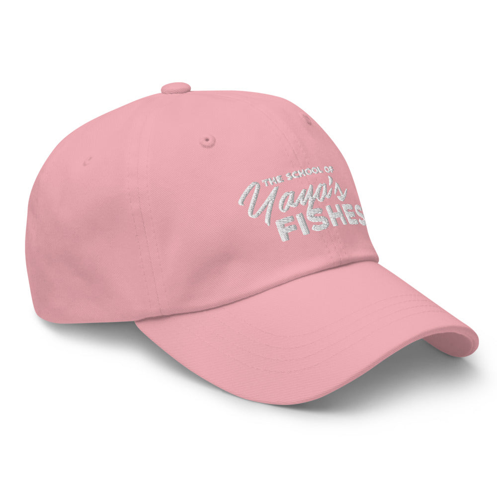 Description: Classic Dad Ball Cap in light pink with white embroidered logo for The School of Yaya’s Fishes.